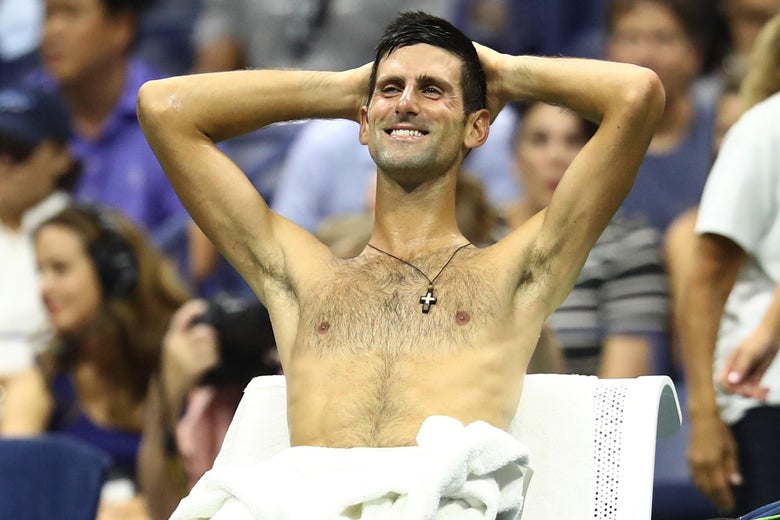 Novak Djokovic of Serbia smiles during break in play.